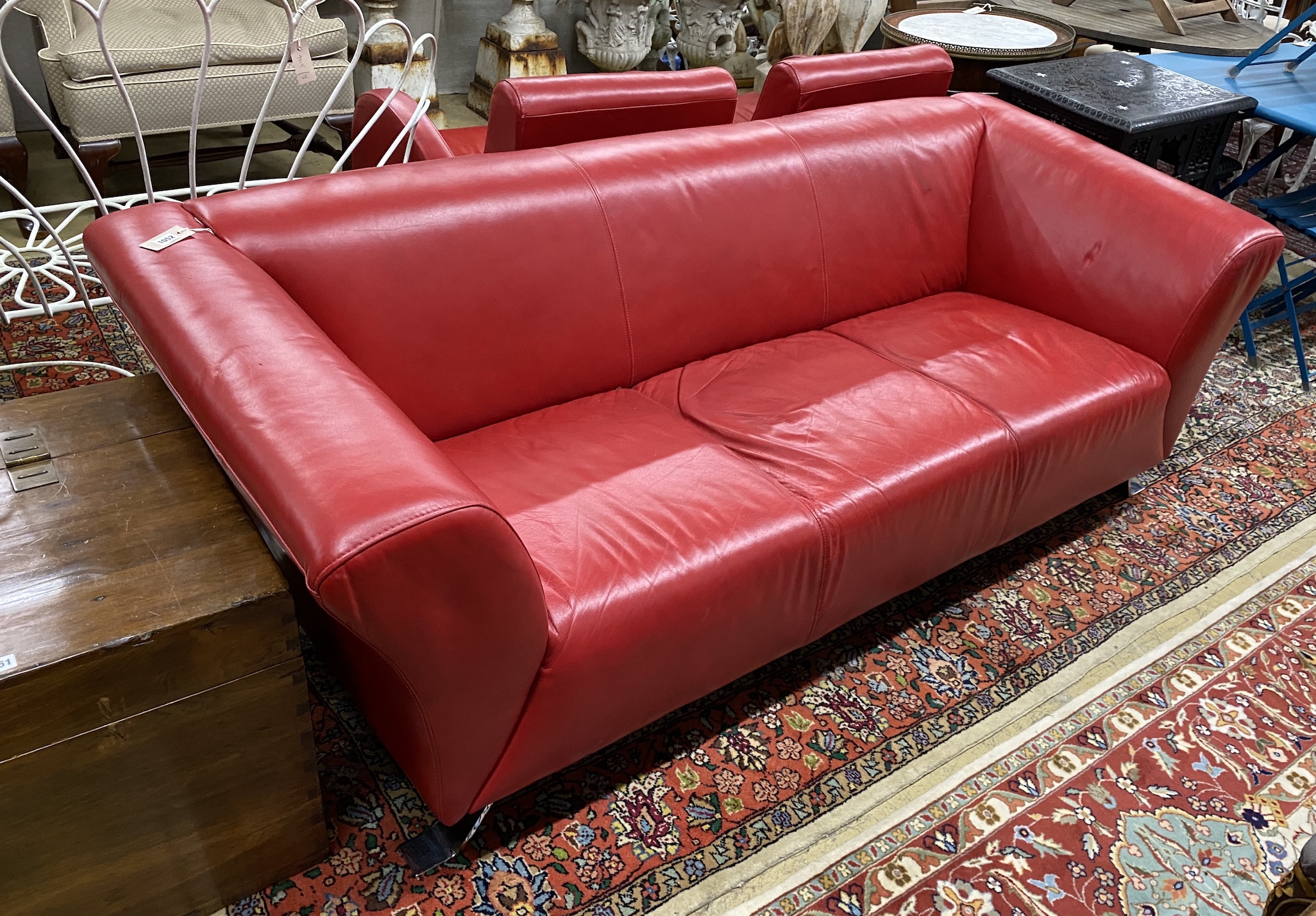 A contemporary leather three seater settee, length 204cm, width 86cm, height 70cm and two similar swivel armchairs on chrome bases